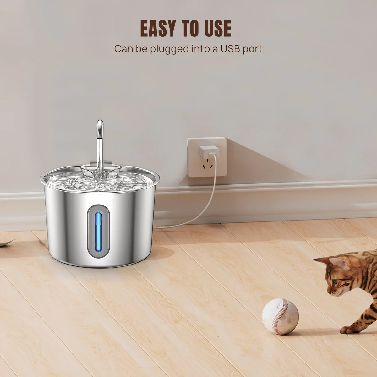 USB-powered pet water fountain plugged in on a wooden floor with a cat nearby