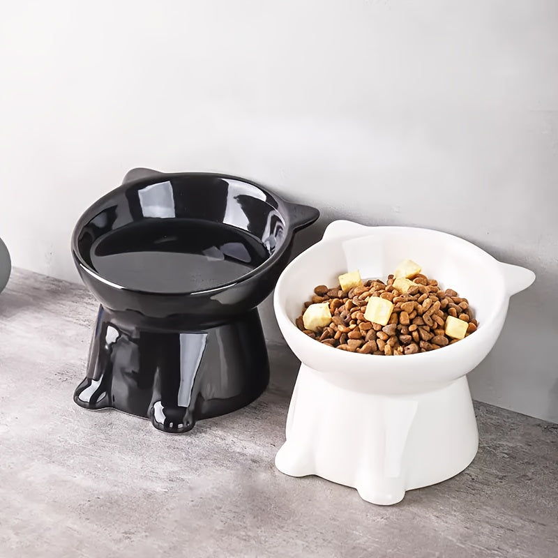 Black and white raised tilted cat bowls with dry food
